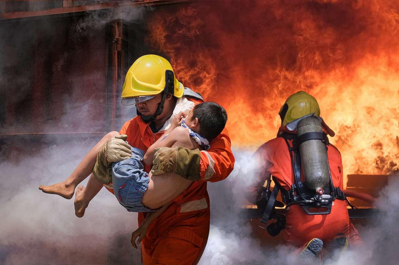 firefighter-holding-child-boy-save-him-fire-smoke
